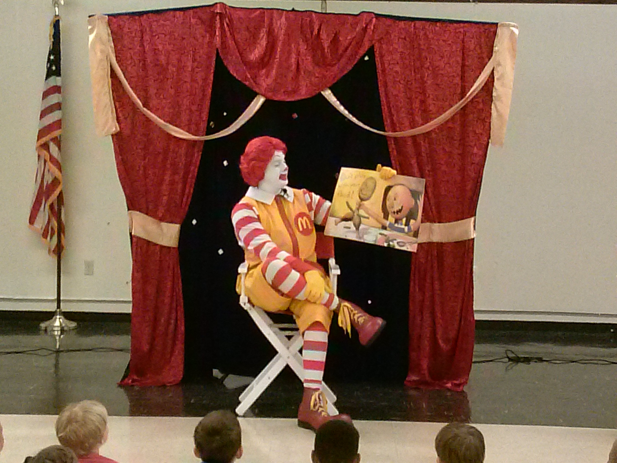 Ronald McDonald reads to children during ELC's Reading with Ronald Event.